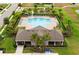 Aerial view showcasing the community pool, lounge area, playground, and lush landscaping at 2000 White Pelican Ter, Sanford, FL 32771