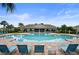 Resort-style community pool with lounge chairs, landscaping, and a covered pavilion at 2000 White Pelican Ter, Sanford, FL 32771