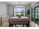 Cozy dining area features a modern light fixture, large window and sliding glass door at 2000 White Pelican Ter, Sanford, FL 32771