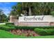 Riverbend community sign surrounded by beautiful landscaping and palm trees at 2000 White Pelican Ter, Sanford, FL 32771