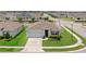 Overhead view of a single-story home with a well-kept lawn, landscaping, two-car garage, and neutral color scheme at 2000 White Pelican Ter, Sanford, FL 32771