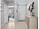 Inviting foyer with neutral tones, tile flooring, and a view leading to a bedroom at 2000 White Pelican Ter, Sanford, FL 32771