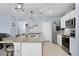 Bright kitchen with stainless steel appliances, granite countertops, and pendant lighting at 2000 White Pelican Ter, Sanford, FL 32771