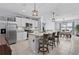 Modern kitchen features stainless steel appliances, granite countertops, and island seating, perfect for entertaining at 2000 White Pelican Ter, Sanford, FL 32771