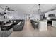 Open-concept design with kitchen island seating and inviting living room with a leather couch at 2000 White Pelican Ter, Sanford, FL 32771