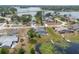 Expansive aerial of a home, lush greenery, and lake access at 2055 Little Farms Ct, Deltona, FL 32738