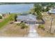 Aerial view of a home, large yard, fenced area, and lake access at 2055 Little Farms Ct, Deltona, FL 32738
