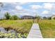 The backyard boasts a private dock, expansive green space, and screened pool at 2055 Little Farms Ct, Deltona, FL 32738