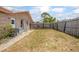 Spacious fenced backyard with grass, a ladder, and a brick home at 2055 Little Farms Ct, Deltona, FL 32738