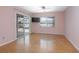 Bedroom with light wood floors and sliding glass doors to the outside pool and lake at 2055 Little Farms Ct, Deltona, FL 32738