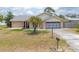 Charming brick home with a well-manicured lawn and a palm tree, featuring a spacious driveway at 2055 Little Farms Ct, Deltona, FL 32738