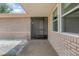 Front Entrance of the home with brick exterior and a screened front door at 2055 Little Farms Ct, Deltona, FL 32738