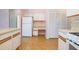 Bright kitchen featuring white cabinetry, laminate countertops, and white appliances at 2055 Little Farms Ct, Deltona, FL 32738