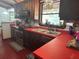 Charming kitchen features wood cabinets, red countertops, and natural light at 2068 Pennsylvania Dr, Deland, FL 32724