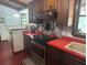 Charming kitchen features wood cabinets, red countertops, and stainless steel appliances at 2068 Pennsylvania Dr, Deland, FL 32724