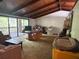 Vintage living room featuring high ceilings, a ceiling fan, and sliding glass doors to the patio at 2068 Pennsylvania Dr, Deland, FL 32724