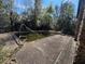 Backyard pool with a slide that needs cleaning, surrounded by natural foliage at 2068 Pennsylvania Dr, Deland, FL 32724