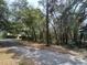 Serene road bordering a wooded area, offering privacy and a natural setting at 2068 Pennsylvania Dr, Deland, FL 32724