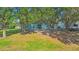 View of the rear of the home showing the green space and lawn at 2110 3Rd Ave, Deland, FL 32724