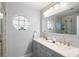 Bathroom featuring double sink vanity, decorative octagon window, and glass shower at 2110 3Rd Ave, Deland, FL 32724