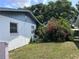 An exterior shot showing the backyard's space and mature landscaping, adding to the property's natural charm at 2210 Se 1St St, Orange City, FL 32763