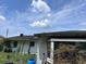 Exterior view of the home's backyard with siding, vegetation, and a glimpse of the sky at 2210 Se 1St St, Orange City, FL 32763