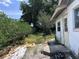 Backyard of the home, showing the need for landscape maintenance; equipment is scattered in the foreground at 2210 Se 1St St, Orange City, FL 32763