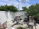 Backyard patio area, enclosed with a white fence and shade trees, creating a private retreat at 2210 Se 1St St, Orange City, FL 32763