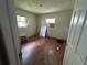 Bedroom featuring hardwood floors, neutral walls, and natural light streaming through the windows at 2210 Se 1St St, Orange City, FL 32763