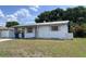 Quaint single-story home with a simple design and front yard, presenting a cozy curb appeal at 2210 Se 1St St, Orange City, FL 32763