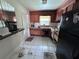 Functional kitchen with wood cabinetry, white appliances, and ample counter space at 2210 Se 1St St, Orange City, FL 32763