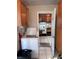 Convenient laundry area adjacent to the kitchen with washer and storage cabinets at 2210 Se 1St St, Orange City, FL 32763