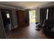 Cozy living room with hardwood floors, detailed molding, and a front door leading to the exterior at 2210 Se 1St St, Orange City, FL 32763