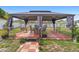 View of covered backyard gazebo with outdoor seating and tile flooring at 2287 Belen Dr, Deltona, FL 32738