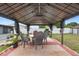 Backyard patio with large gazebo, complete with outdoor table and chairs at 2287 Belen Dr, Deltona, FL 32738