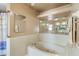 Traditional bathroom features a whirlpool tub and large mirror at 2287 Belen Dr, Deltona, FL 32738