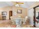 Breakfast nook with archway to kitchen, sliding door to backyard, and seating with patterned cushions at 2287 Belen Dr, Deltona, FL 32738