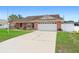 Charming brick home with a two-car garage and well-maintained front yard at 2287 Belen Dr, Deltona, FL 32738