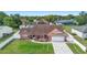 Charming single-story home with brick exterior, lush landscaping, and a two-car garage at 2287 Belen Dr, Deltona, FL 32738