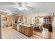 View of kitchen with peninsula, oak cabinets, tile flooring, and adjacent dining area at 2287 Belen Dr, Deltona, FL 32738