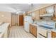 View of kitchen with oak cabinets, white appliances, and tiled floor, flowing into a dining area at 2287 Belen Dr, Deltona, FL 32738