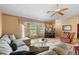 Warm living room with a plush sectional sofa, tile floors, and a cozy atmosphere at 2287 Belen Dr, Deltona, FL 32738