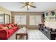 Cozy living room with tile floors, ceiling fan and large windows at 2287 Belen Dr, Deltona, FL 32738
