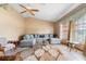 Bright living room featuring a comfortable sectional, ceiling fan, and tiled flooring at 2287 Belen Dr, Deltona, FL 32738