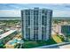 Aerial view featuring an upscale beachfront condo building with private balconies at 2425 S Atlantic Ave # 1202A, Daytona Beach Shores, FL 32118