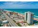 Stunning aerial view of beachfront condos along a scenic coastline with clear turquoise water and a pristine sandy beach at 2425 S Atlantic Ave # 1202A, Daytona Beach Shores, FL 32118