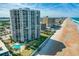 Aerial view of a beachfront high-rise showcasing its proximity to the beach and ocean, plus community pool at 2425 S Atlantic Ave # 1202A, Daytona Beach Shores, FL 32118