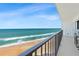 Enjoy the ocean view from this balcony overlooking the beach, a clear sky, and the ocean waves at 2425 S Atlantic Ave # 1202A, Daytona Beach Shores, FL 32118