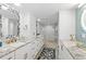 Bright bathroom with double vanity, granite countertop, modern shower, and luxury finishes at 2425 S Atlantic Ave # 1202A, Daytona Beach Shores, FL 32118