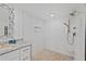 Modern bathroom showcasing a walk-in shower with gorgeous gold fixtures and pebble flooring at 2425 S Atlantic Ave # 1202A, Daytona Beach Shores, FL 32118
